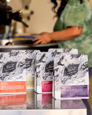 Five 10 oz bags of single-origin coffees roasted by Novel Coffee Roasters.